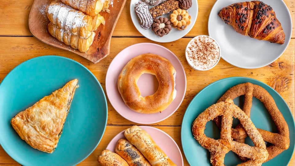 Pretzie’s actual pastries, pretzels, cakes and coffee on a wooden table